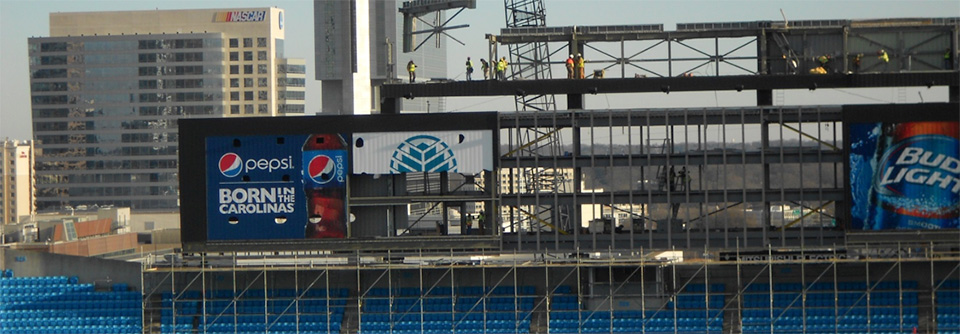 ad on stadium with construction workers